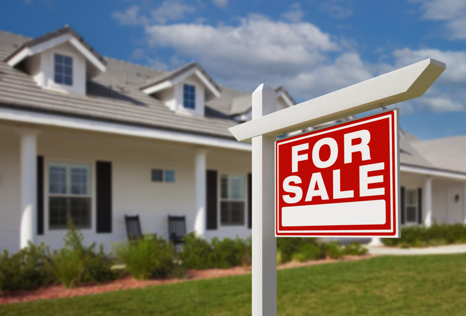 House with a "For Sale" sign outside.