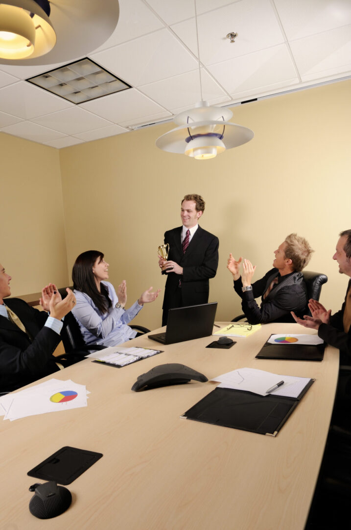 Office meeting celebrating award-winning colleague.